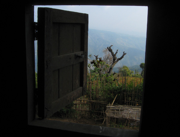Mountain view through a window of a village home